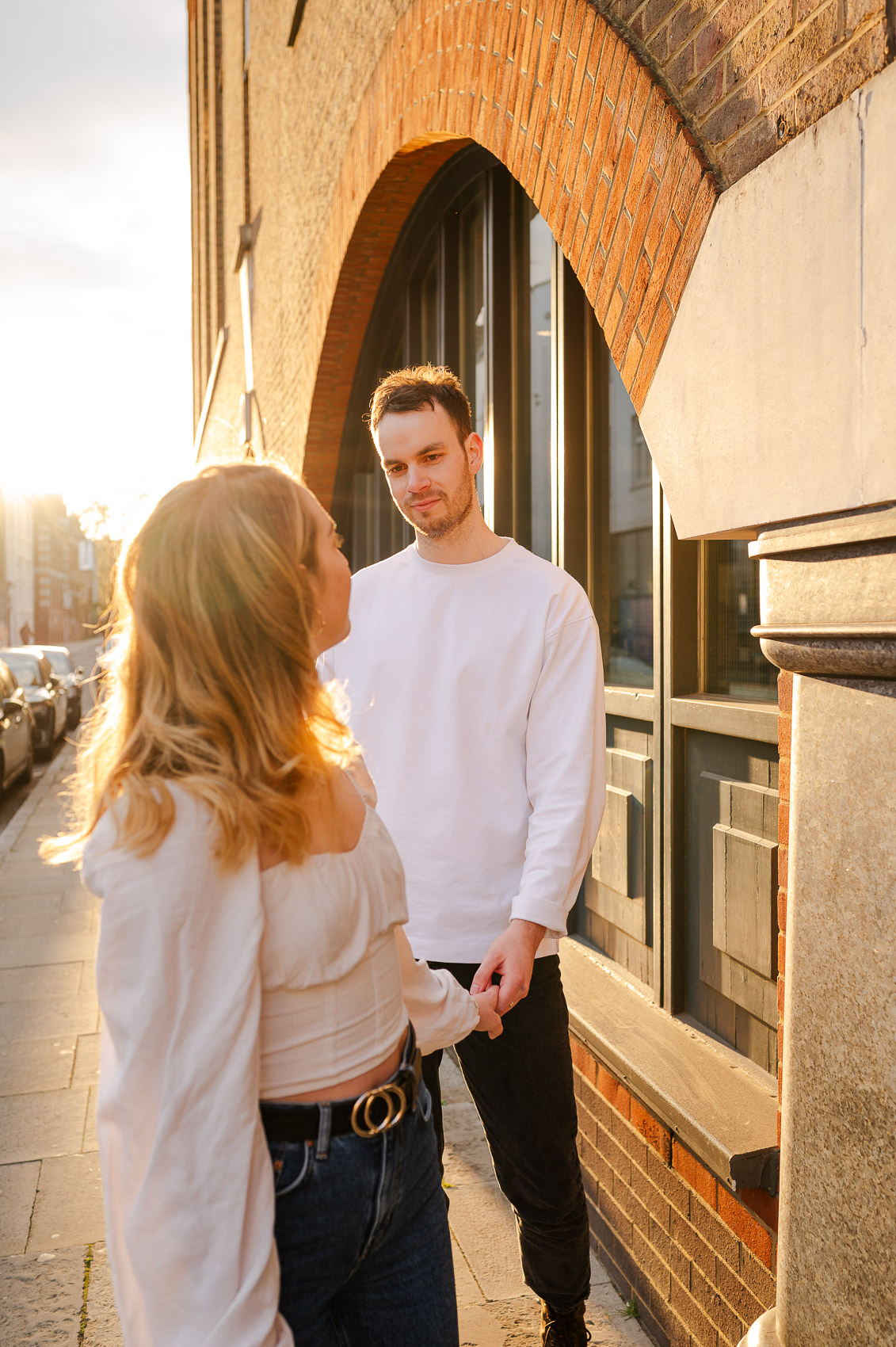 young couple wanders london during golden hour