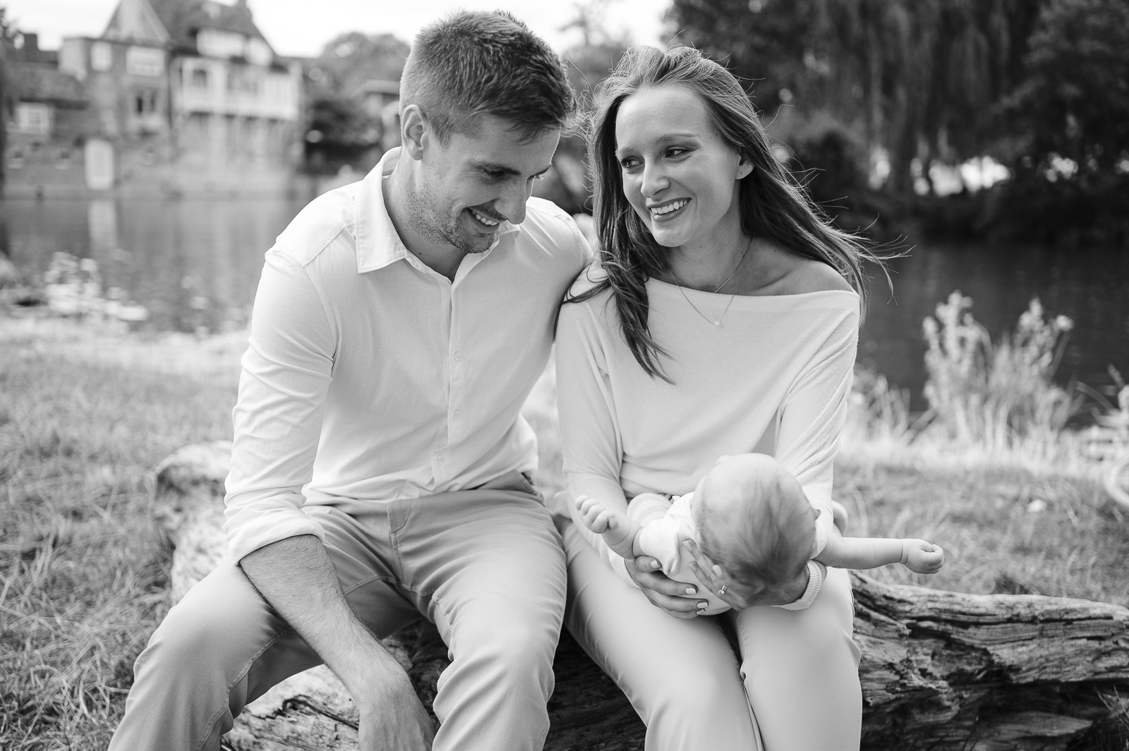 black and white portrait of a young family by the river in cambridge united kingdom